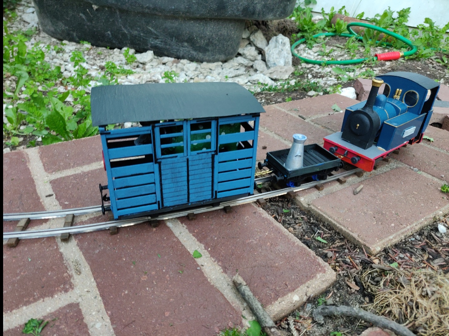 THORNAS poses on a section of temporary track, showing off the new full service dairy train and the state of construction on the patio area.